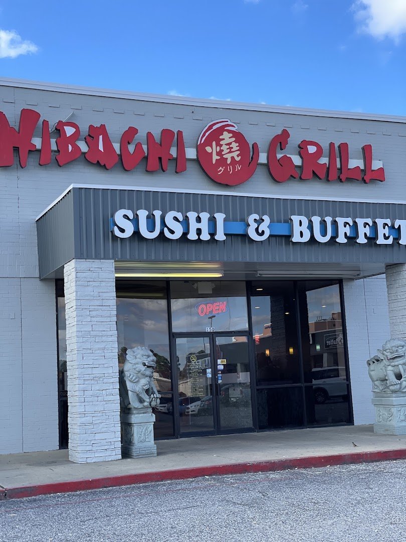 Buffet line with hibachi grill and mixed dishes.